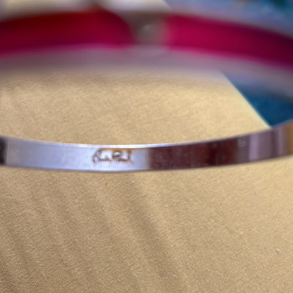 Red bangle with gold tone inner design. - Picture 2 of 2